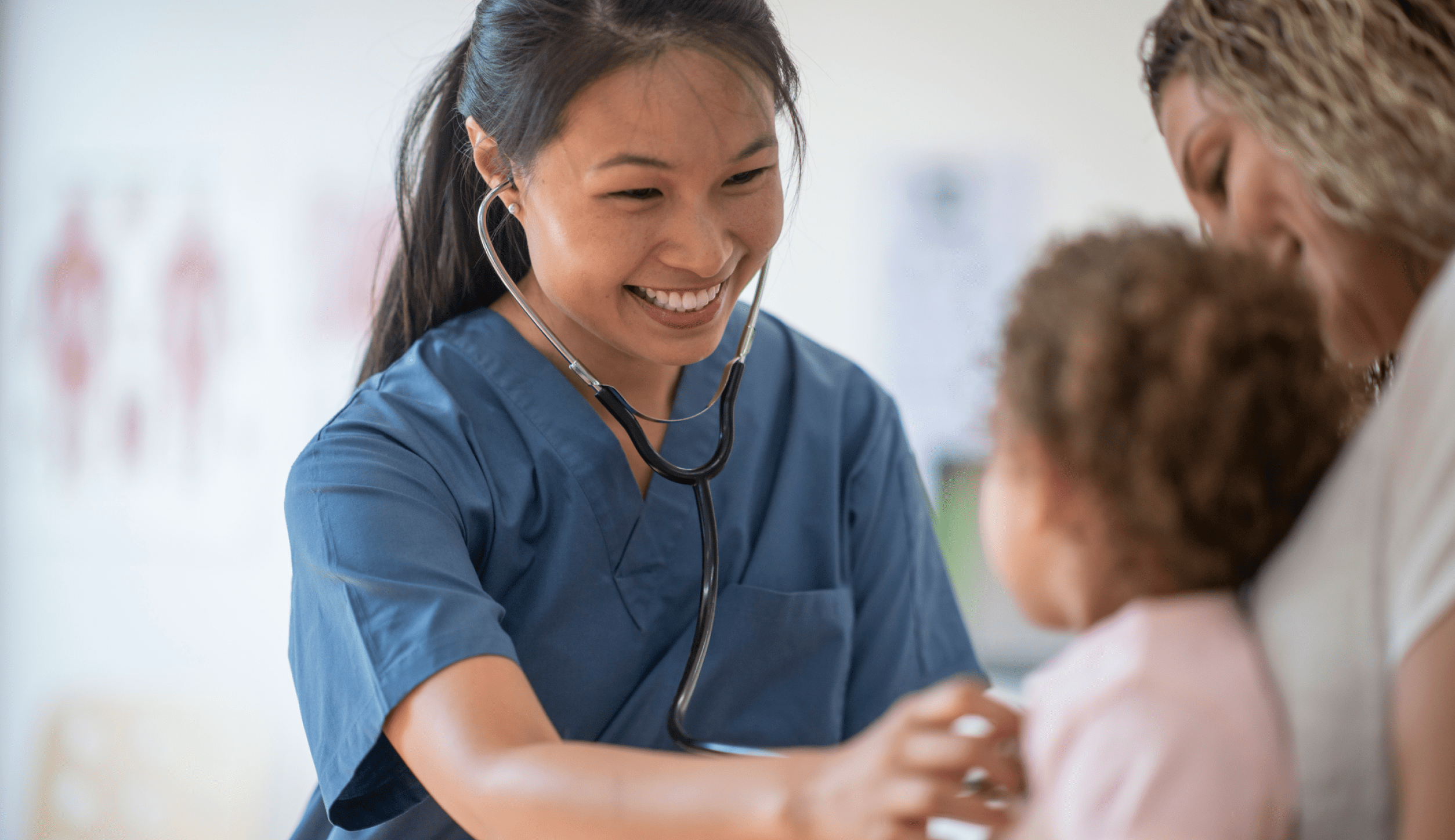 A photo of a female medical professional listing to a child's chest.